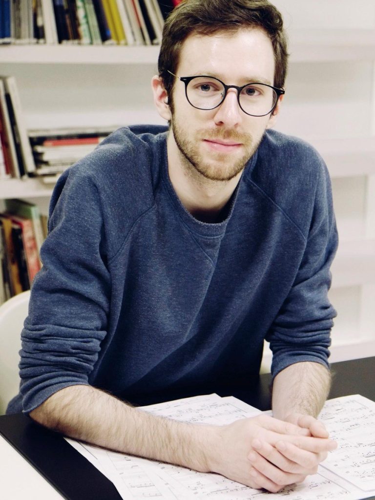 Portrait of Lukas Hövelmann-Köper at a desk with scores